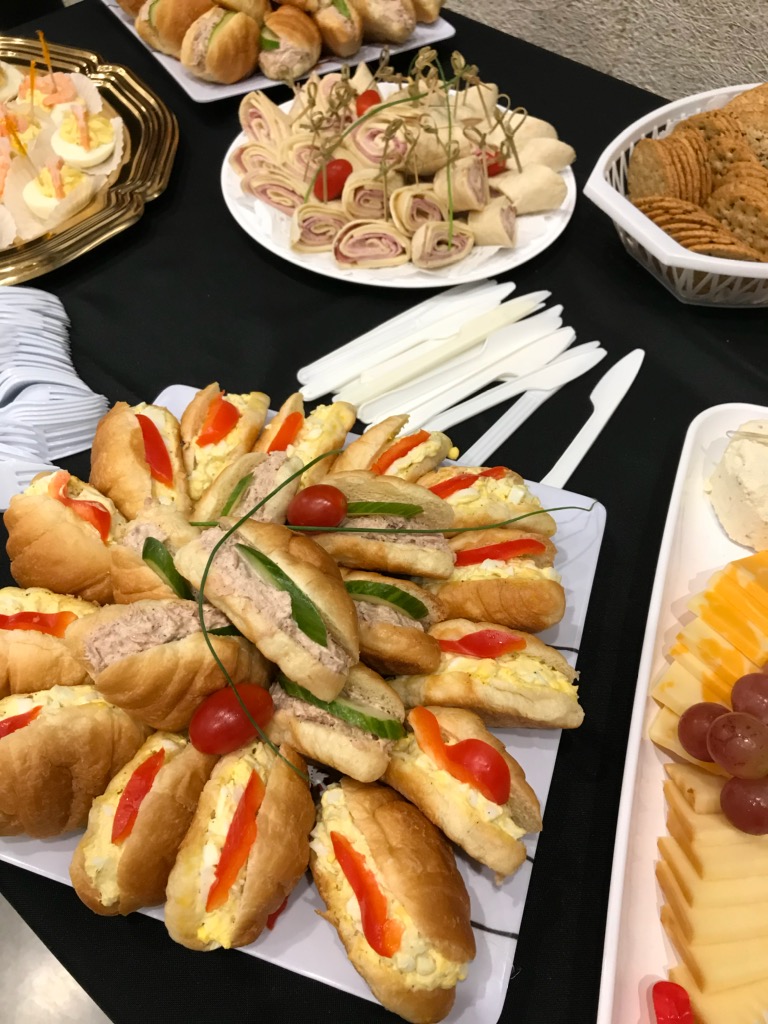 A table with sandwiches and appetizers