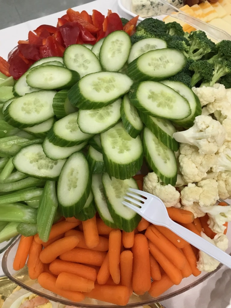 A bowl of sliced fresh fruits and vegetables